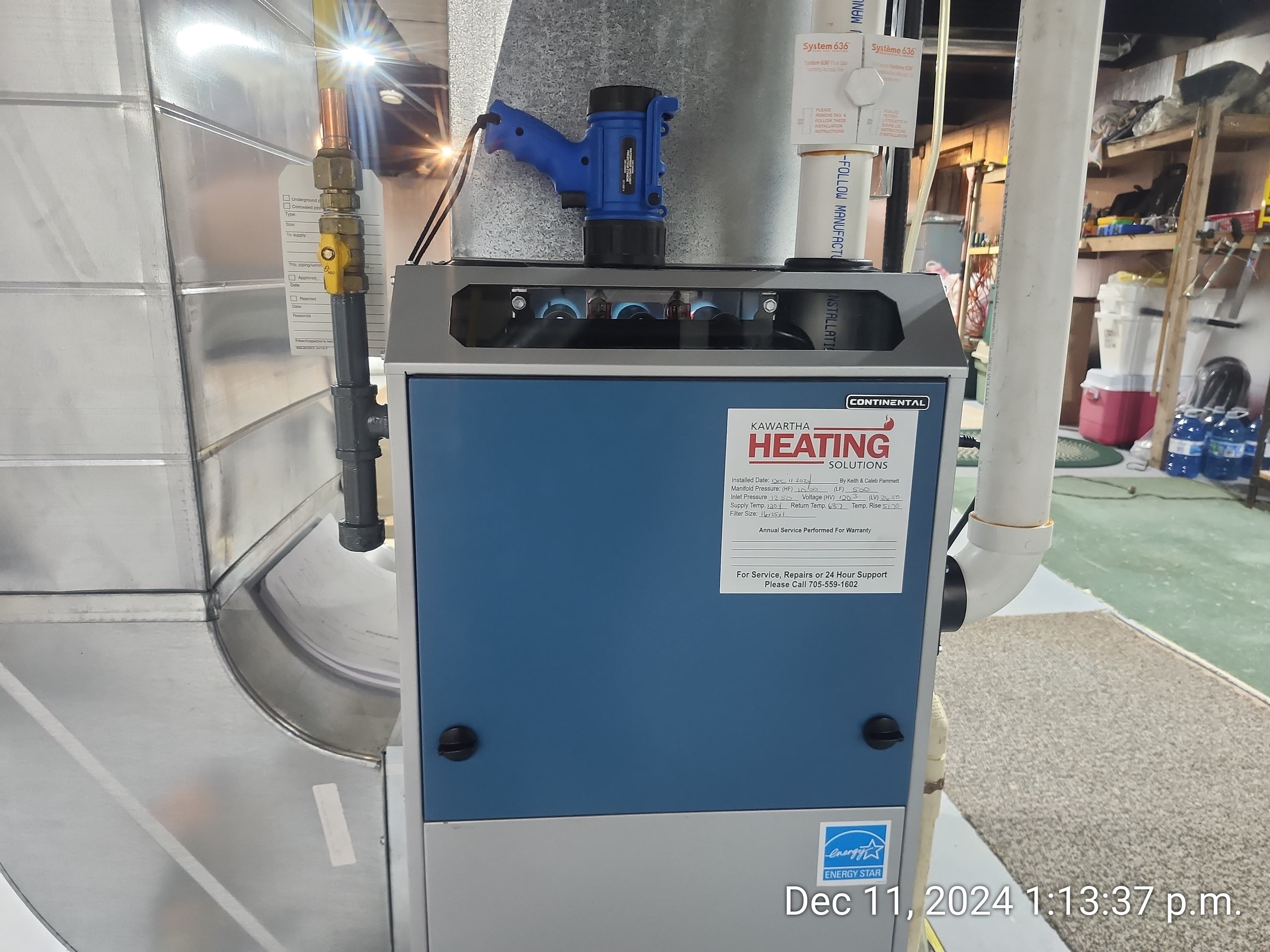 Continental furnace with blue front panel and Kawartha Heating Solutions label, connected to metal ductwork.