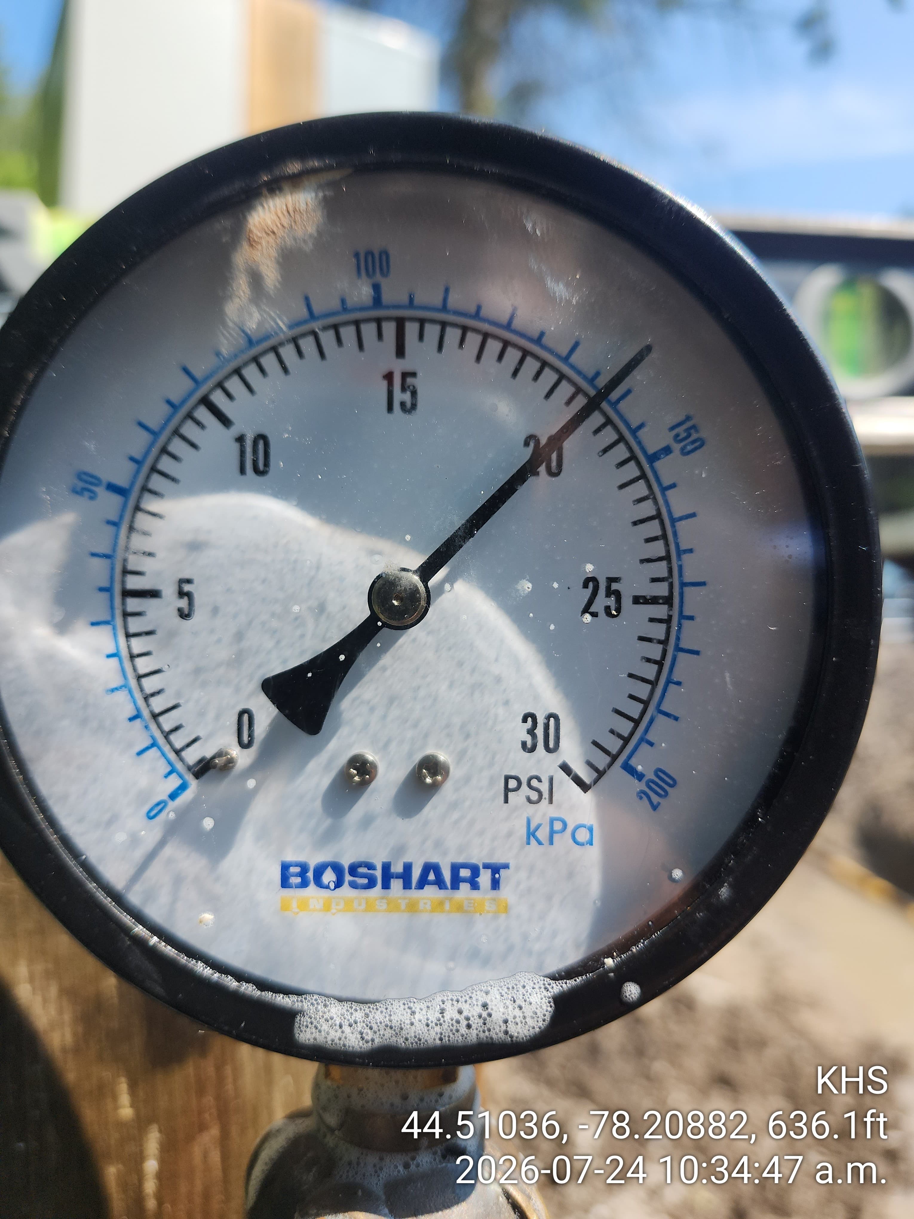Boshart Industries pressure gauge reading 22 PSI, covered in white soap foam and bubbles.