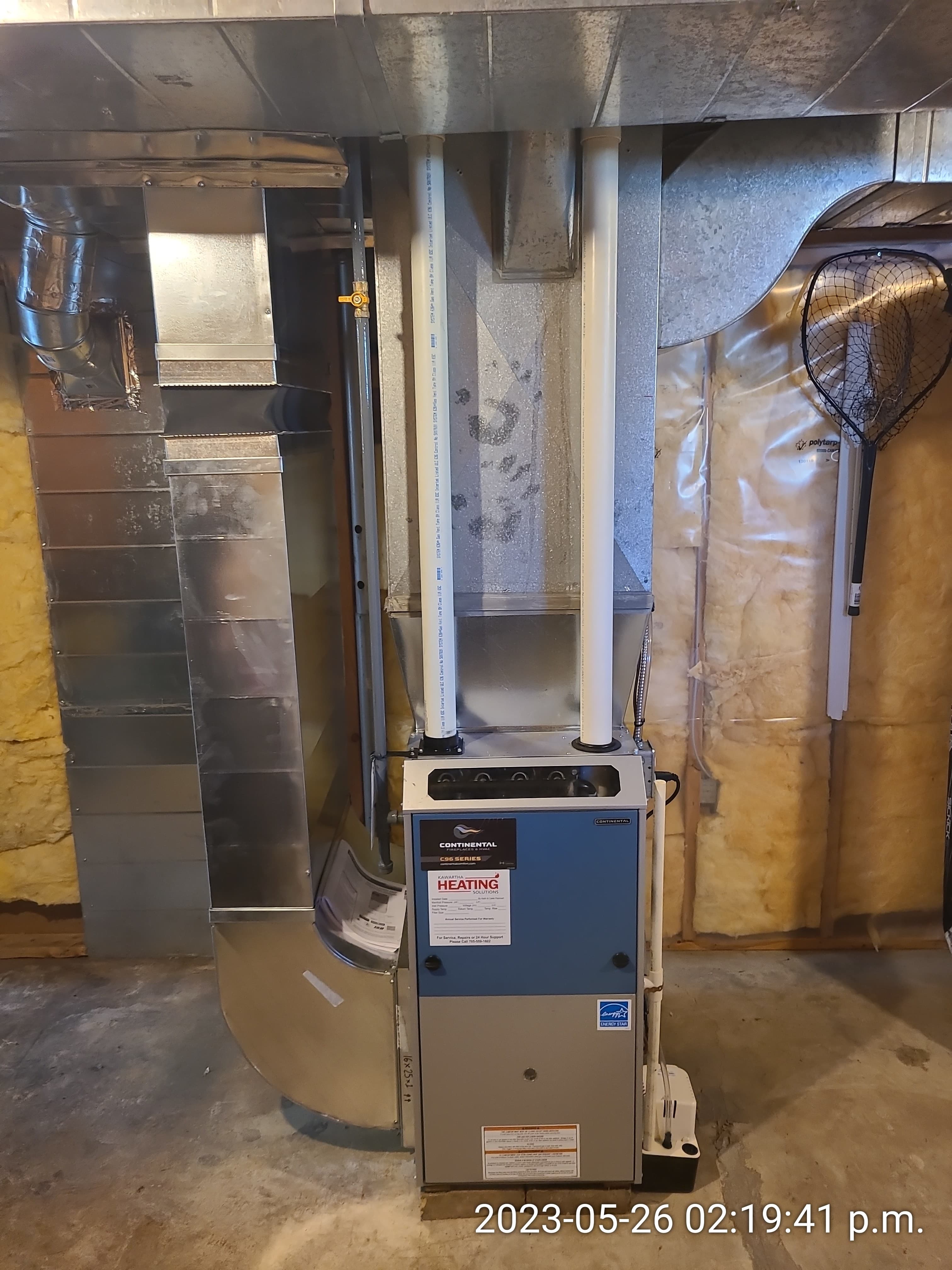 Continental furnace with metal ductwork and white PVC pipes in an unfinished, insulated basement.
